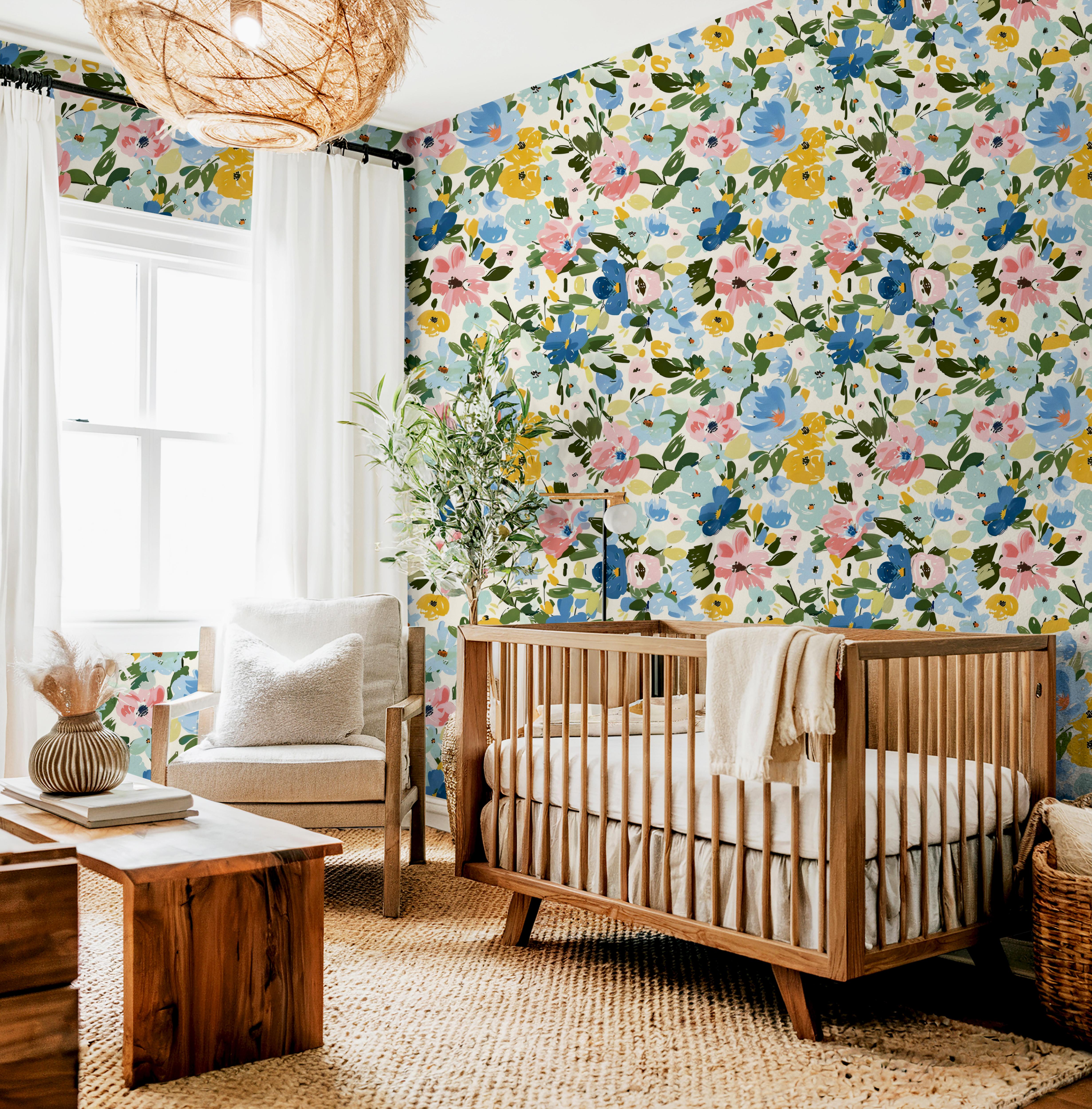 Wallpaper 1648: A vibrant floral wallpaper featuring hand-painted watercolor flowers in shades of blue, pink, and yellow with lush green leaves. The large-scale botanical design creates a statement wall, perfect for nurseries, bedrooms, and accent spaces.